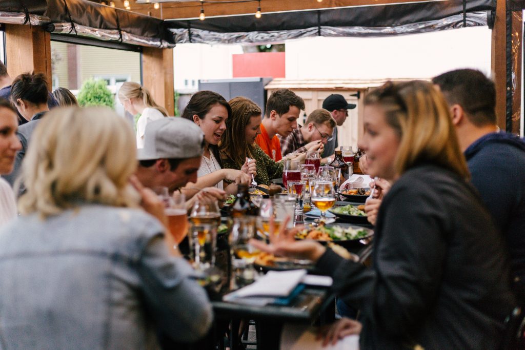 People eating and having fun but over-eating can lead to food retention