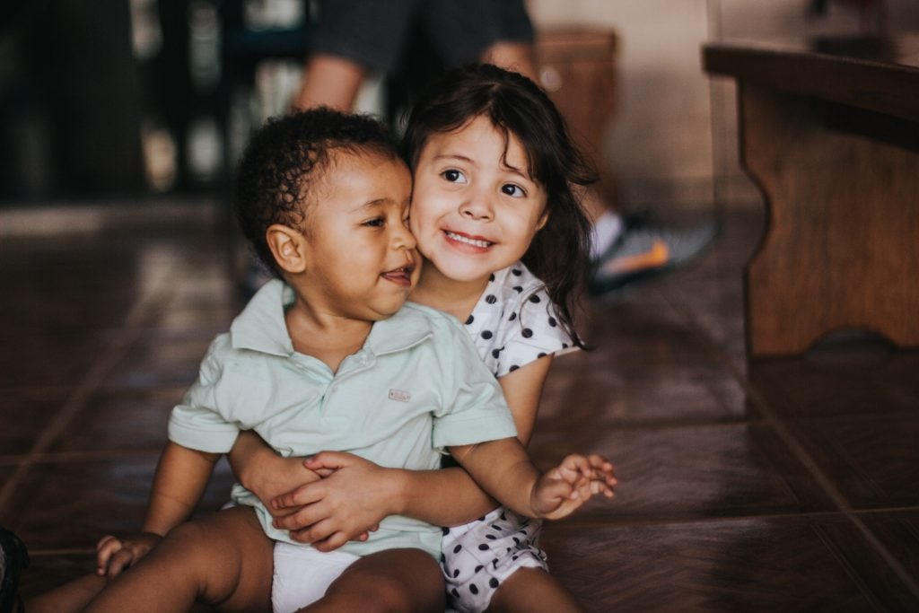 Children sitting on the floor smiling