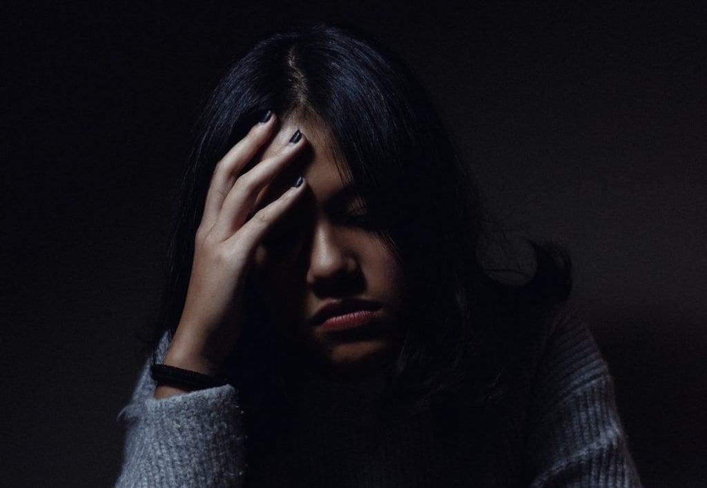 Woman Worrying - why does my stomach hurt?