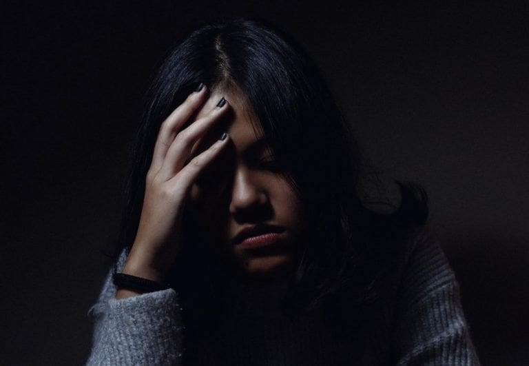 Woman Worrying - why does my stomach hurt?