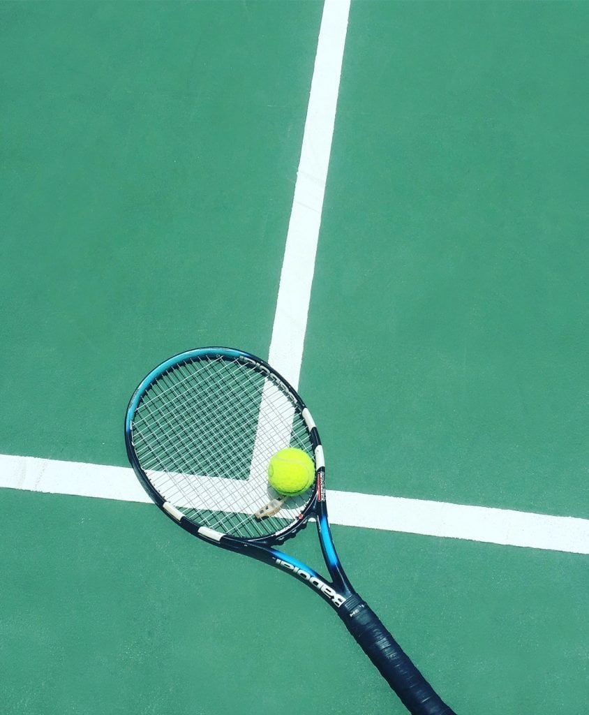 tennis racket and ball on field