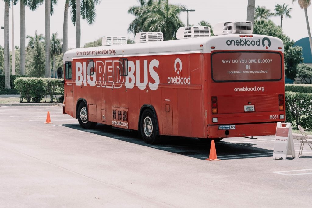 red and white coca cola bus on road during daytime