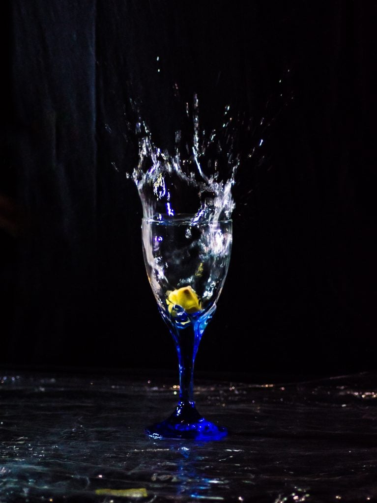 clear wine glass with yellow liquid