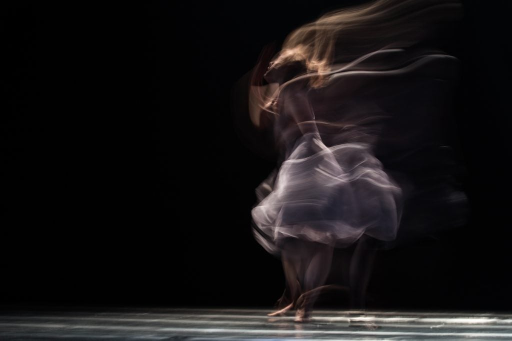 dancing woman on concrete pavement: ming men powers the dance of the shen mind