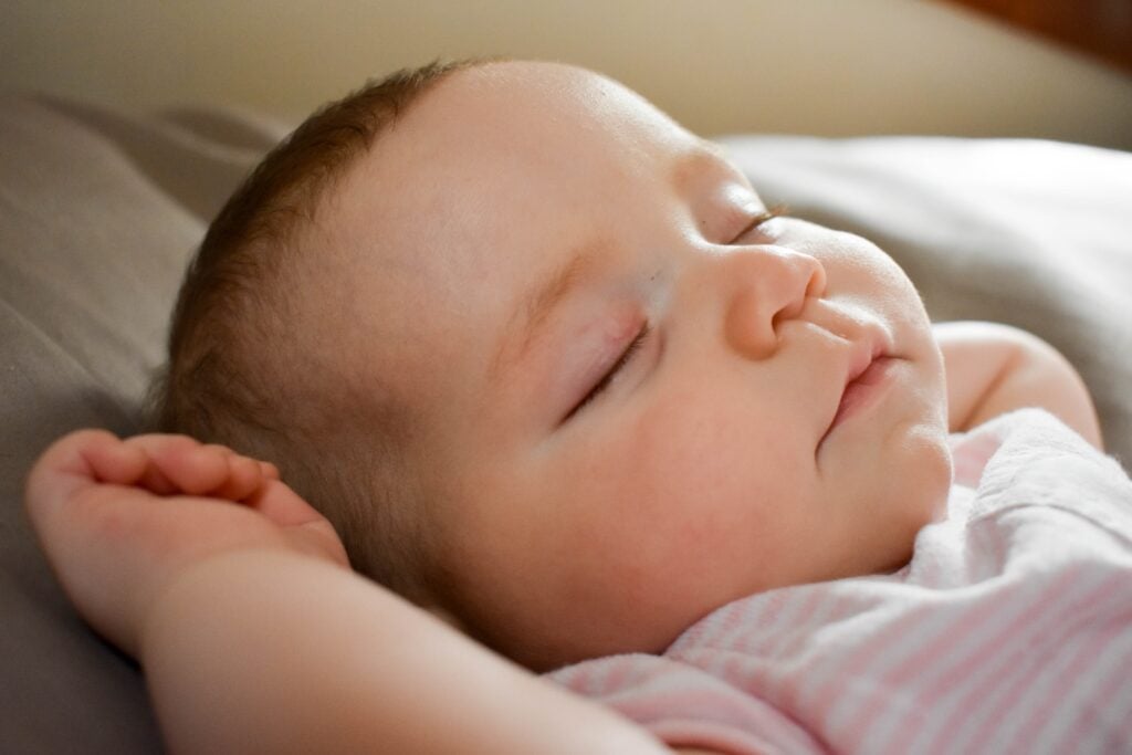 sleeping baby on gray cushion. Sleep is really important if you have Liver Blood deficiency.