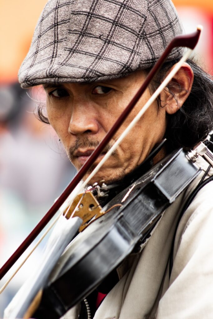 Man in gray hat playing violin - too slowly? Try moxibustion!