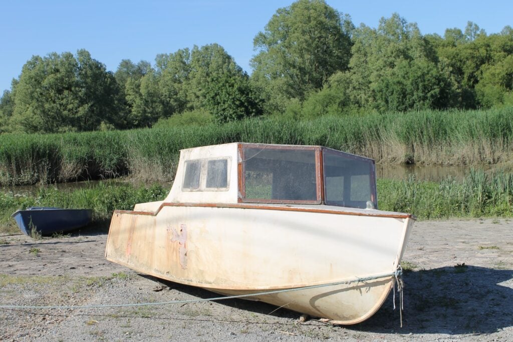 white and brown boat on gray sand during daytime: dryness is a symptom of liver yin deficiency