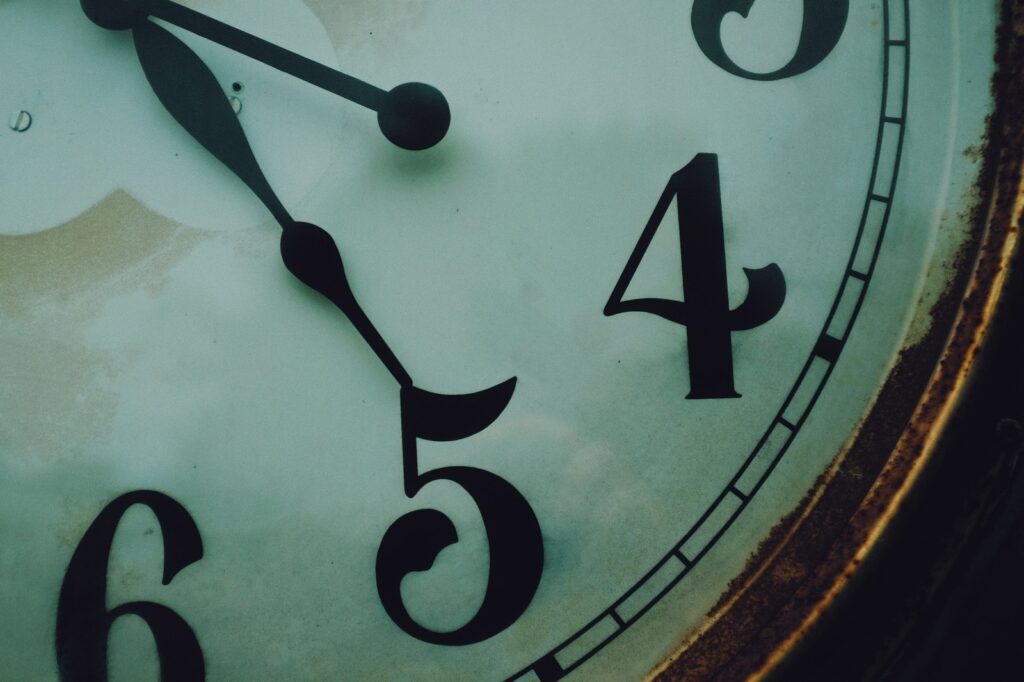brown wooden framed analog clock