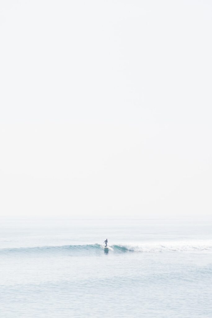 person surfing on sea waves during daytime