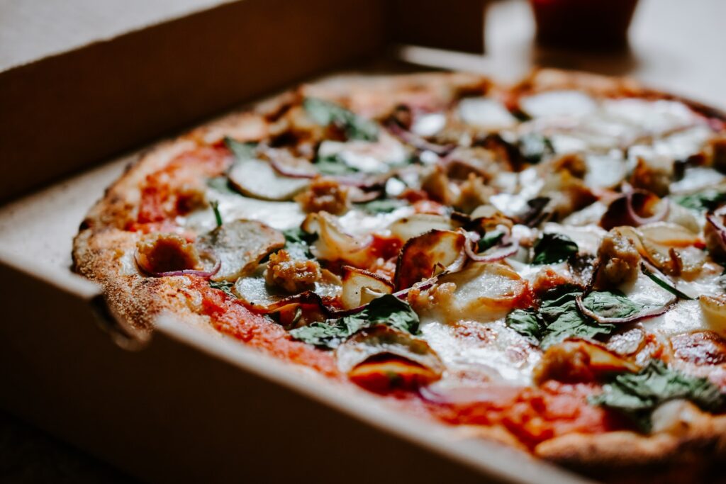 pizza with green and red bell pepper and cheese. Too much junk food causes dry skin!