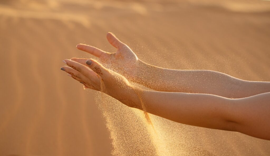persons feet on brown sand