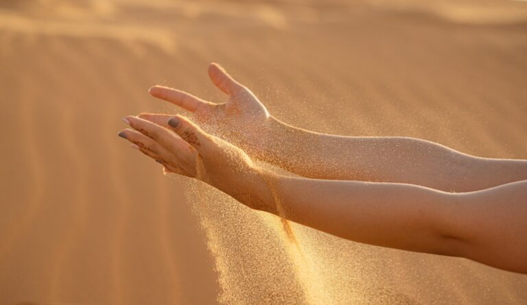 persons feet on brown sand