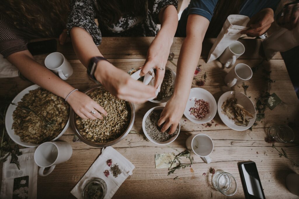 people mixing items on bowl. The right prescription of Chinese herbs can help dry skin.