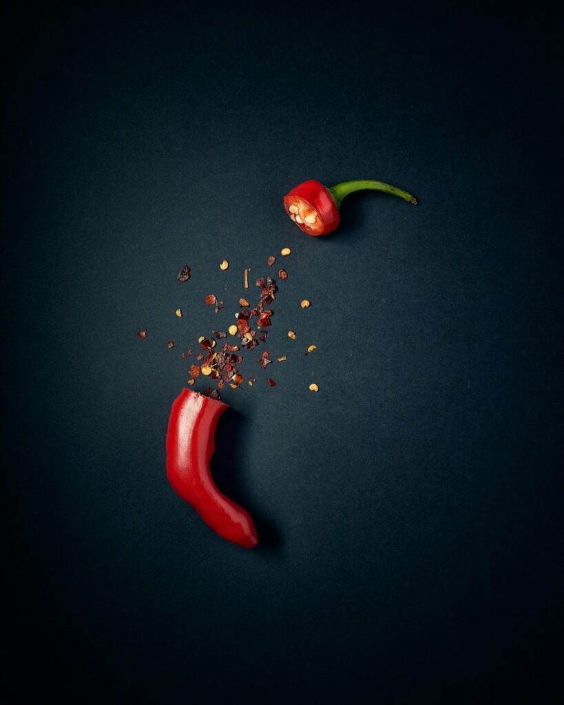 red chili pepper with green leaves