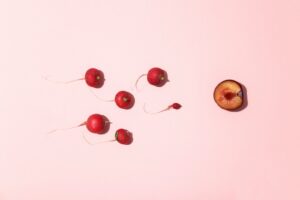red cherry fruits on white surface