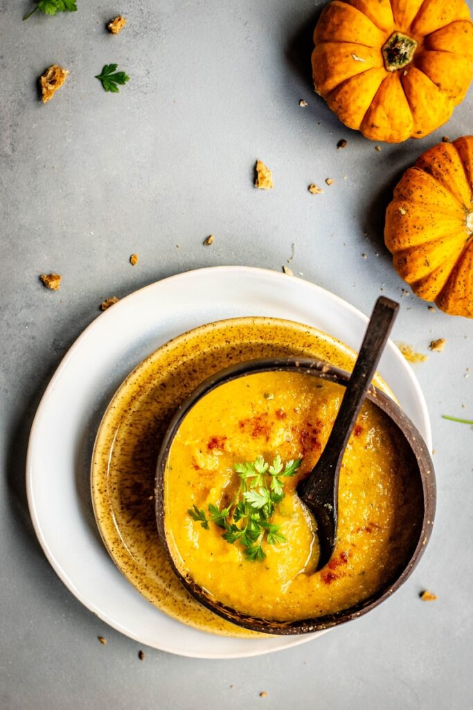 bowl of soup near two pumpkins: great form of erectile dysfunction treatment