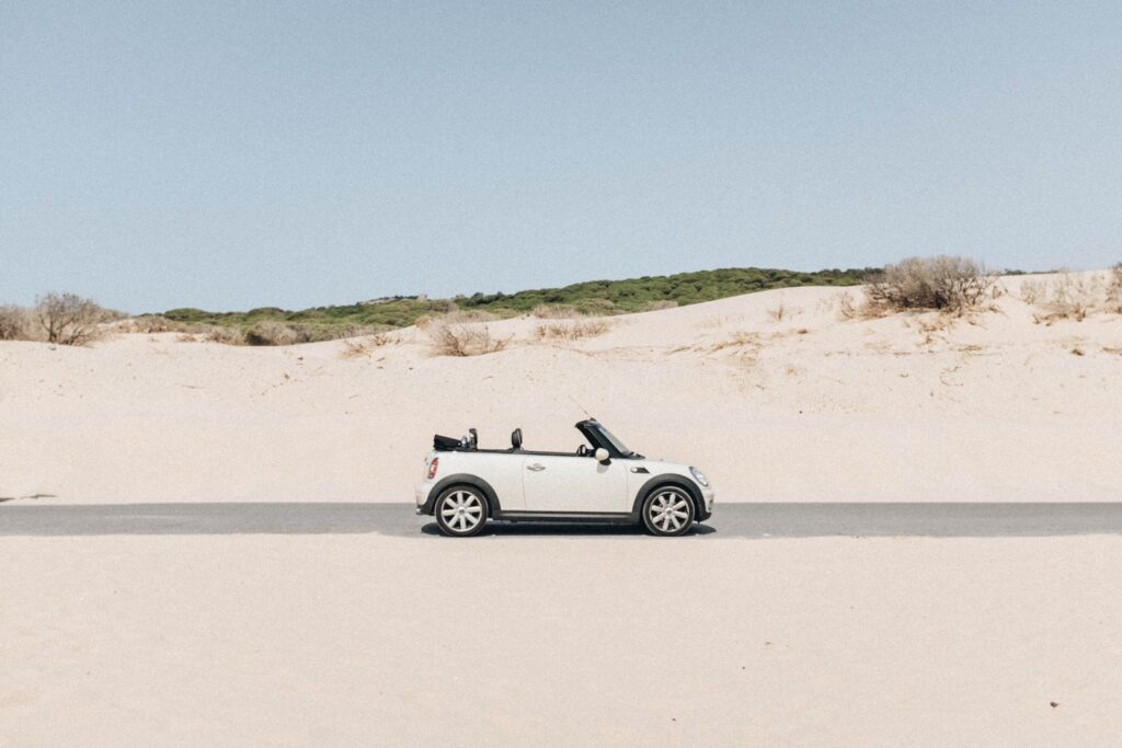 convertible coupe in middle of road
