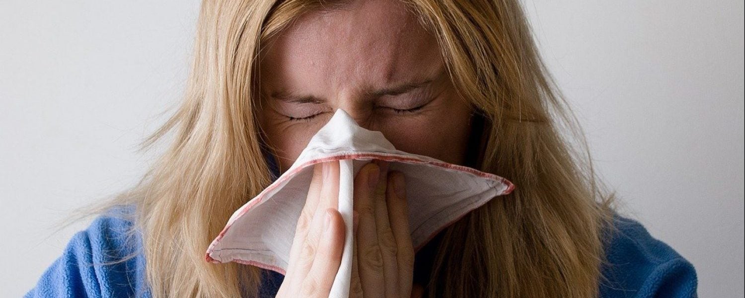 Woman blowing nose